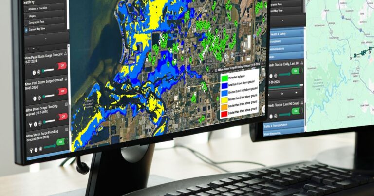 Computer monitors display a geospatial disaster response platform with flood forecasting maps, storm surge data, and property location markers, illustrating how Progress Residential uses technology to monitor severe weather risks and support rapid response efforts.